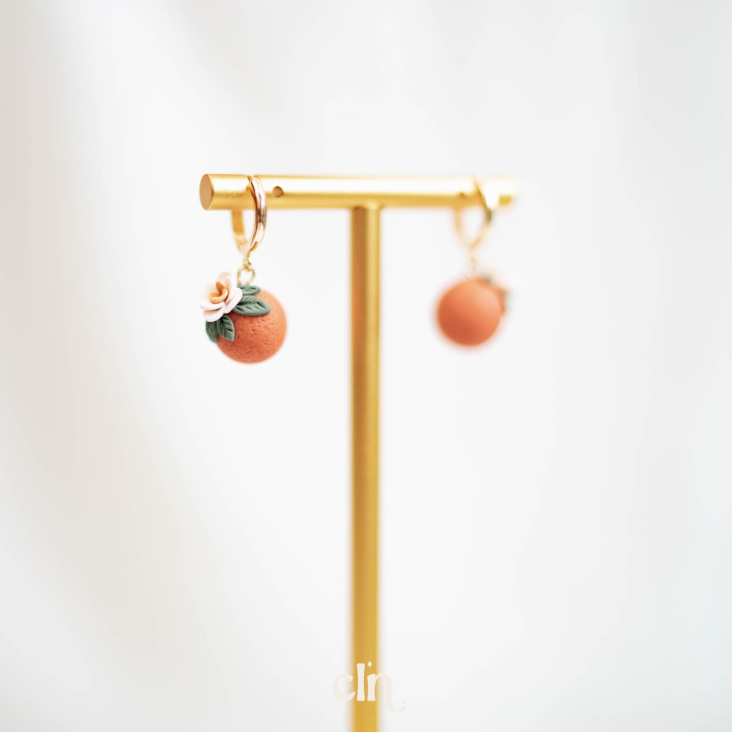 Orange huggie hoops - Earrings - CLN Atelier