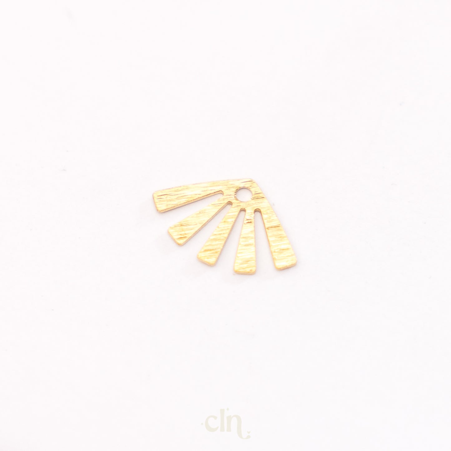 a pair of gold earrings on a white background