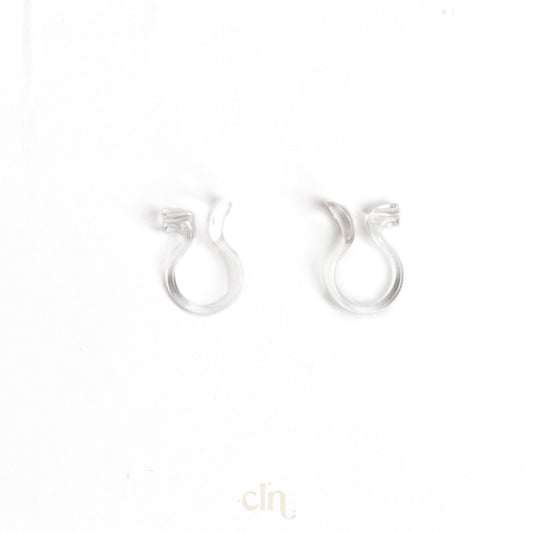 a pair of silver earrings on a white background