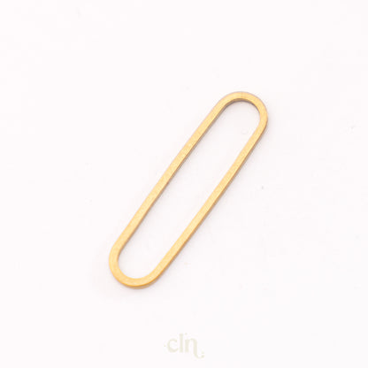 a gold paper clip on a white background