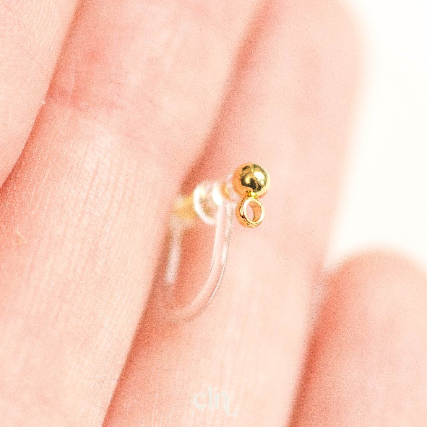 a close up of a person's hand with a ring on it